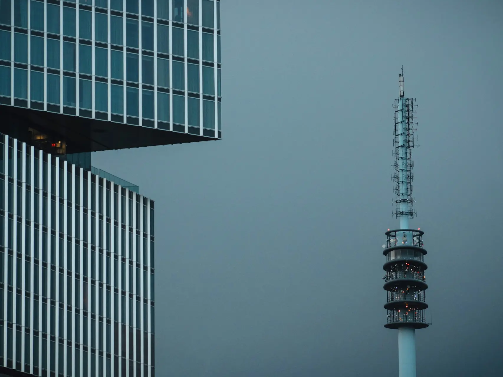 a very tall building next to a very tall tower